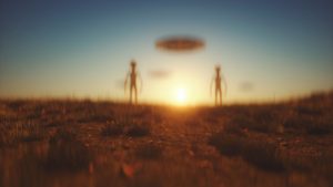 two aliens beneath a flying saucer
